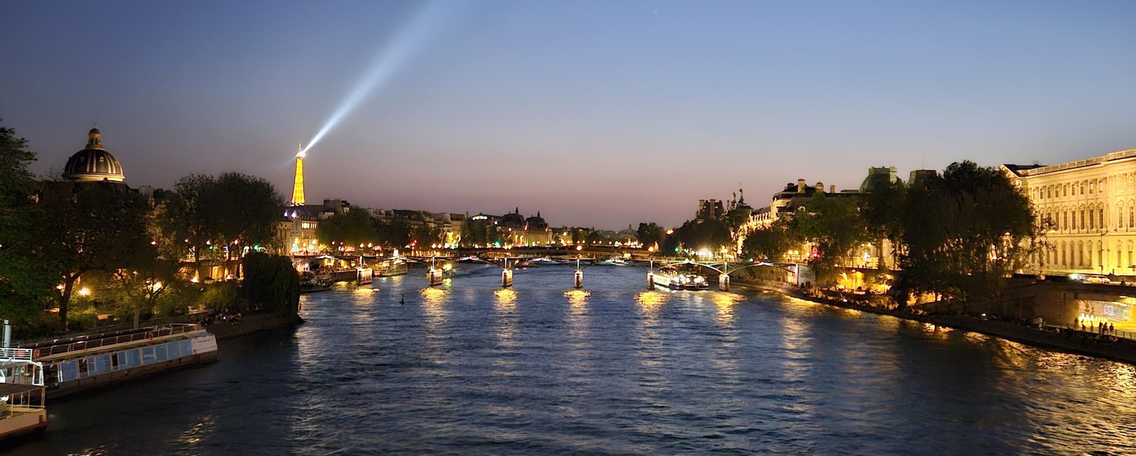 View of the Seine, the Institut de France, and the Eiffel Tower at twilight